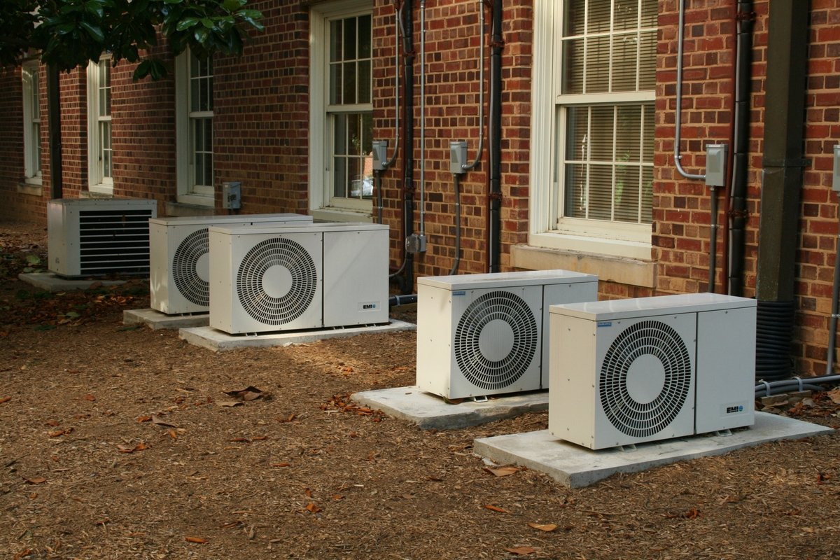 a line of heat pumps on a residential apartment building