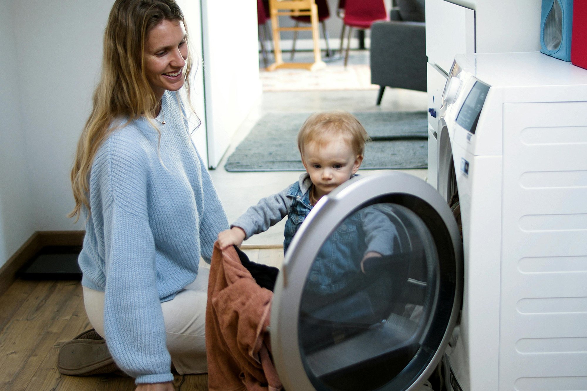 A woman and toddler doing laundry togehter