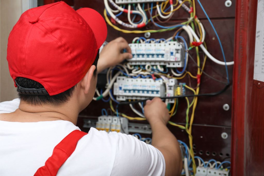 man working on an electrical panel