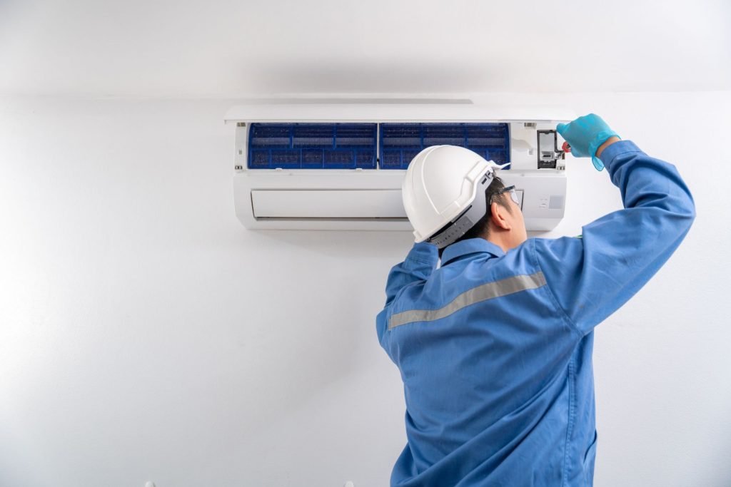 HVAC technician explaining AC replacement cost to Sacramento homeowner during in-home consultation