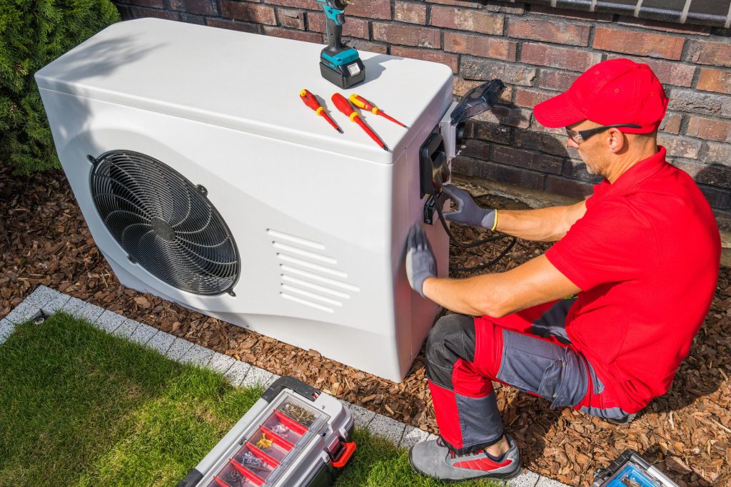 a heating contractor from Elite Heating and AIr installing a heating system for a home