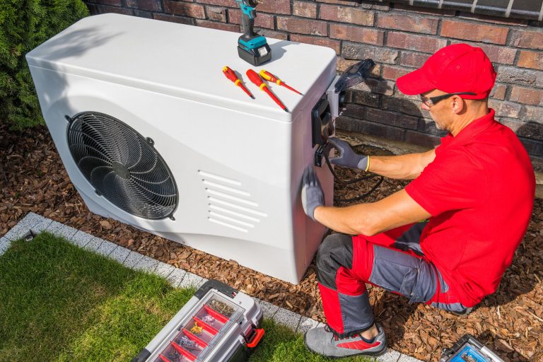 a heating contractor from Elite Heating and AIr installing a heating system for a home