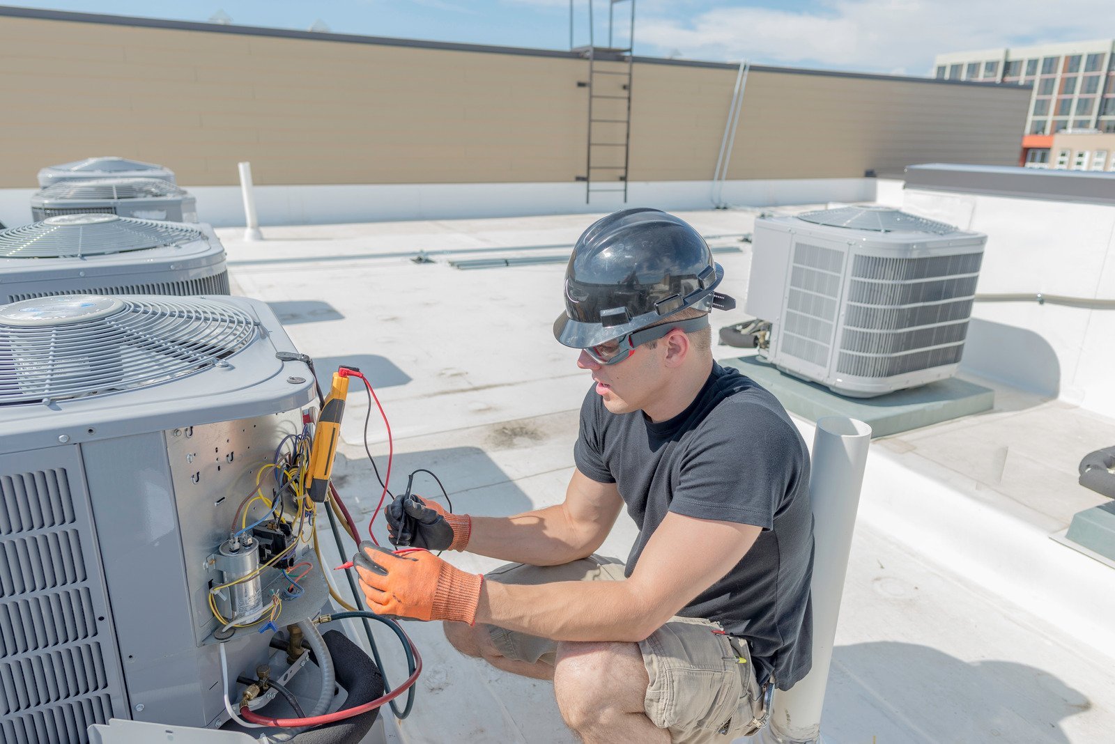 an elite heating and air hvac service technician performing hvac maintenance on a unit