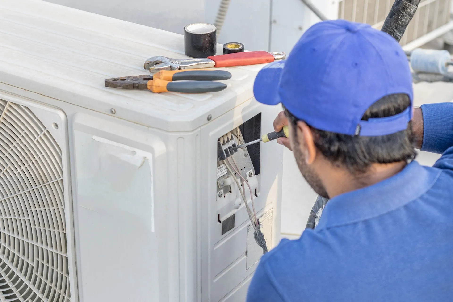 Elite Heating & Air technician evaluating AC replacement cost in Sacramento residence